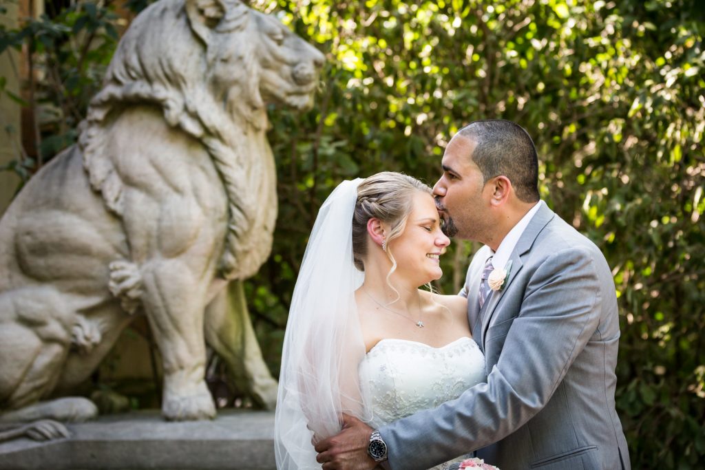 Groom kissing bride at a Bronx Zoo wedding