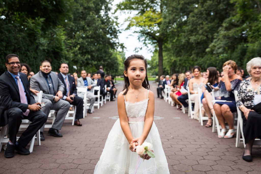 Flower girl walking down aisle at a Bronx Zoo wedding