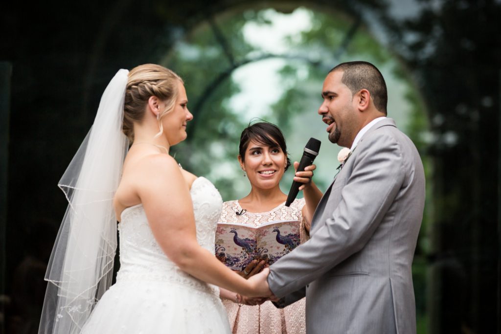 Groom saying vows to bride at a Bronx Zoo wedding