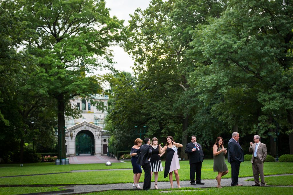 Cocktail hour guests in Astor Court at a Bronx Zoo wedding