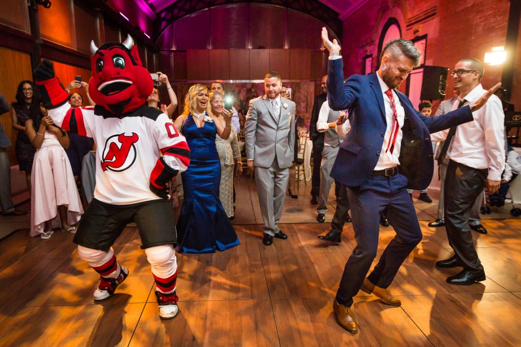 NJ Devil mascot and guest dancing at a Bronx Zoo wedding