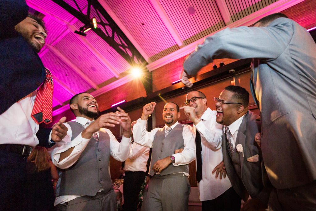 Groom and guests dancing at a Bronx Zoo wedding