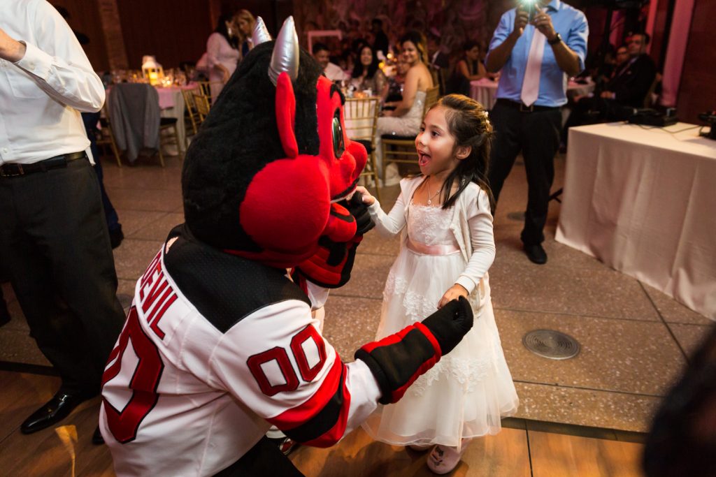 NJ Devil mascot dancing with little girl at a Bronx Zoo wedding