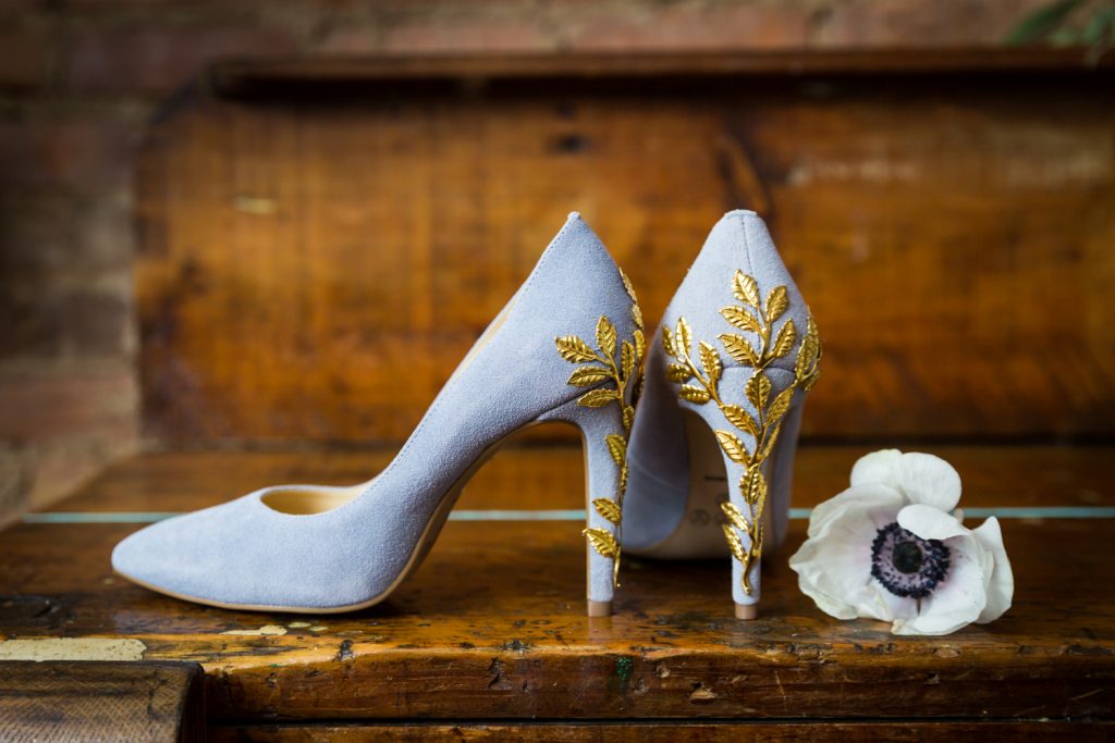 Purple suede heels with gold applique for an article on the pros and cons of a restaurant wedding