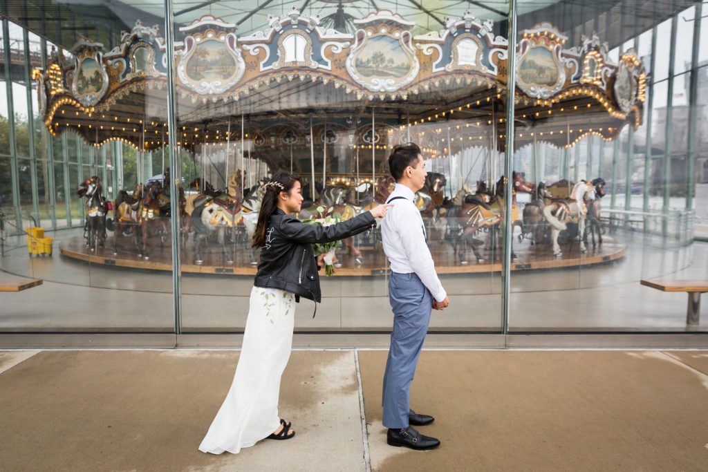 Bride tapping groom on shoulder at first look for an article on the pros and cons of a restaurant wedding