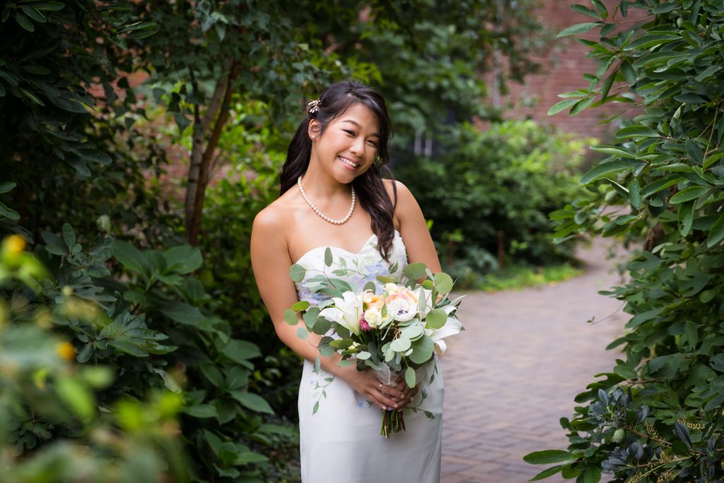 Bride holding bouquet of flowers for an article on the pros and cons of a restaurant wedding