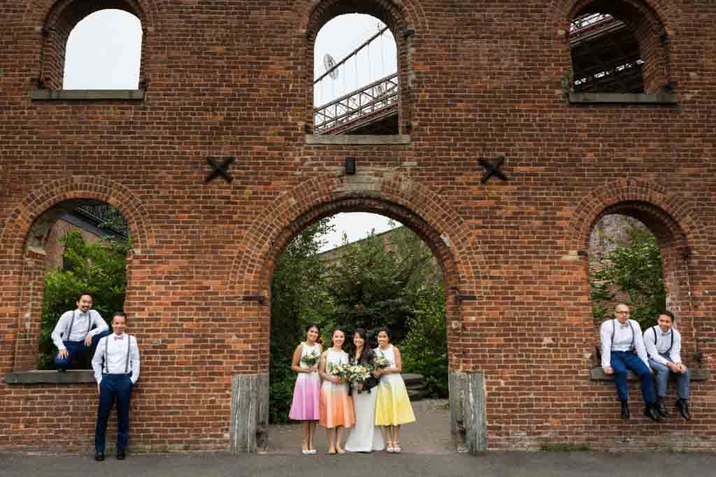 Portrait of bridal party in brick archways of Brooklyn Bridge Park