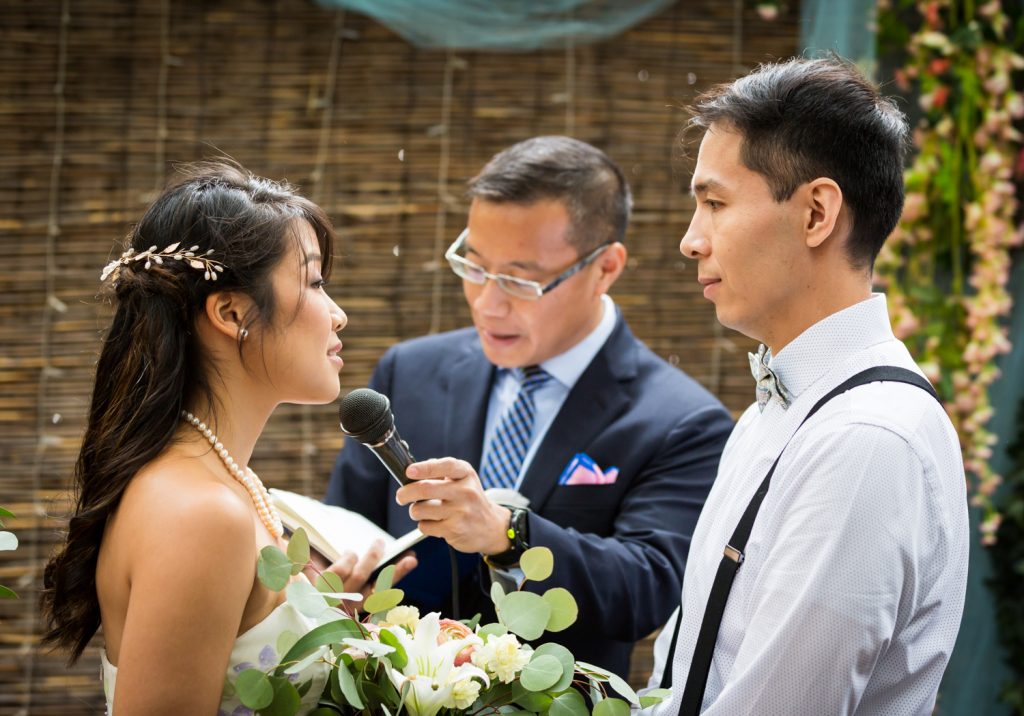 Bride and groom saying vows during restaurant wedding ceremony