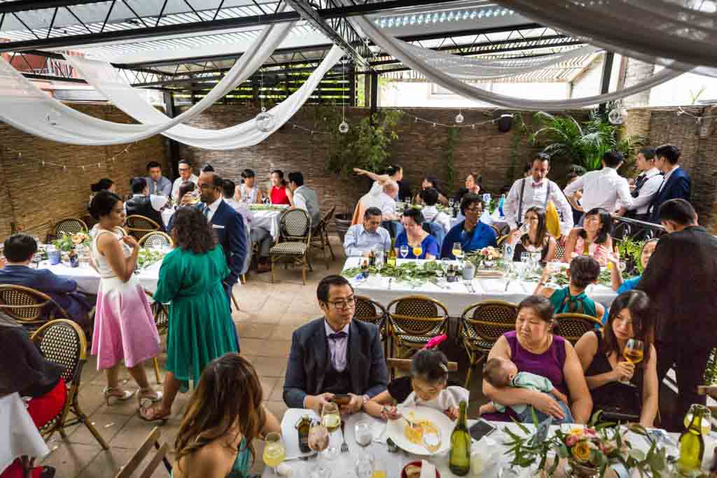 Guests in restaurant patio for an article on the pros and cons of a restaurant wedding