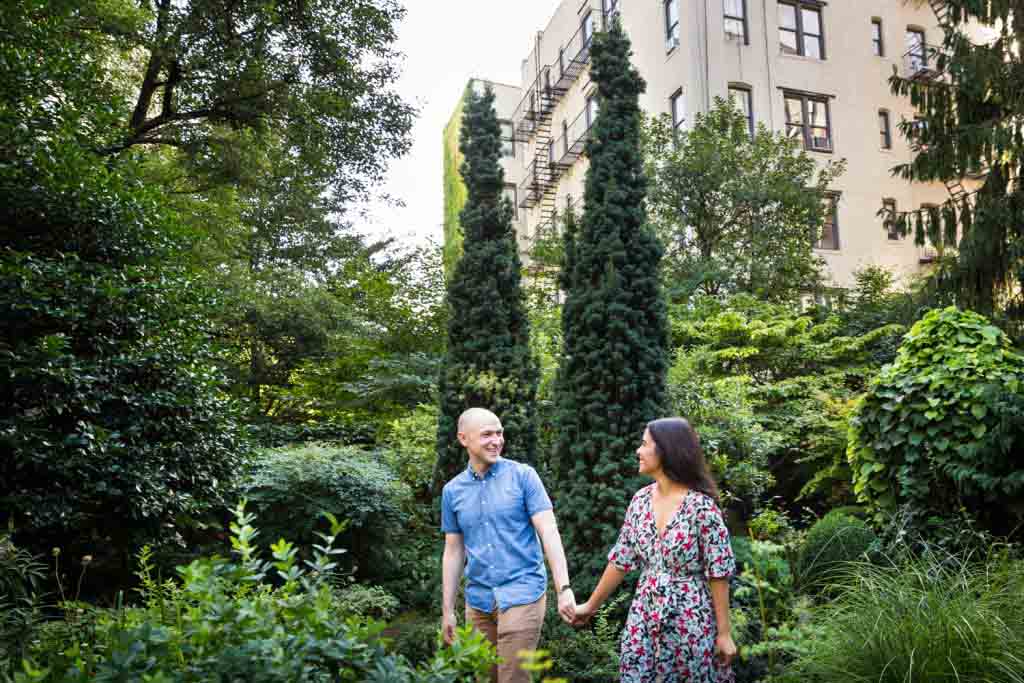 Couple walking in middle of garden at a community garden family portrait session