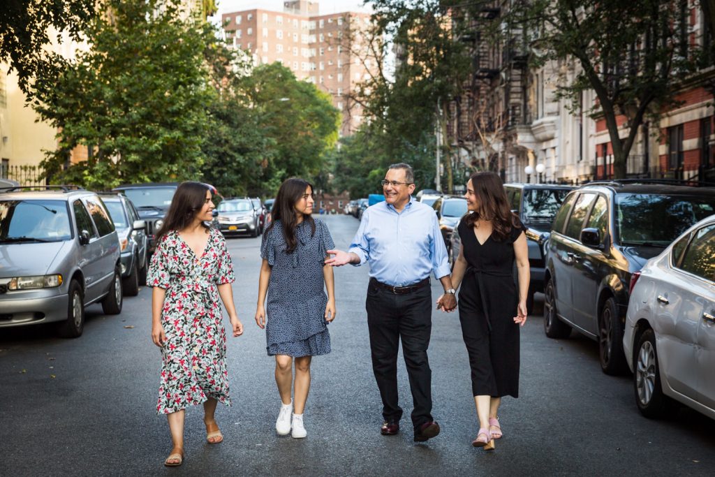 Family walking in middle of East Village street