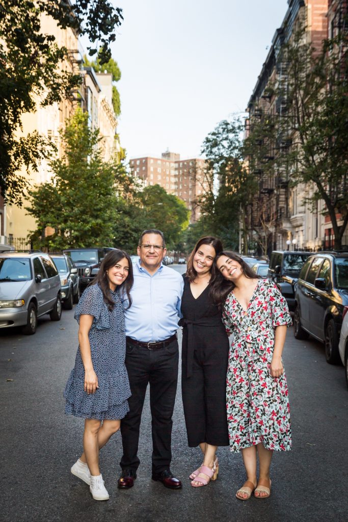 Family standing in middle of East Village street
