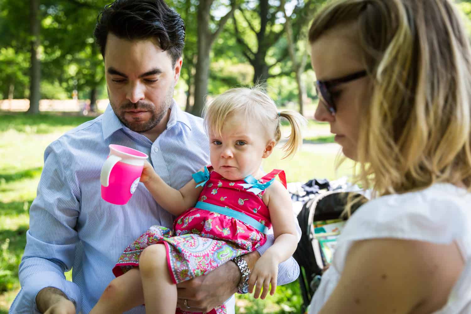 Little girl crying while held by father during a Forest Park family photo shoot