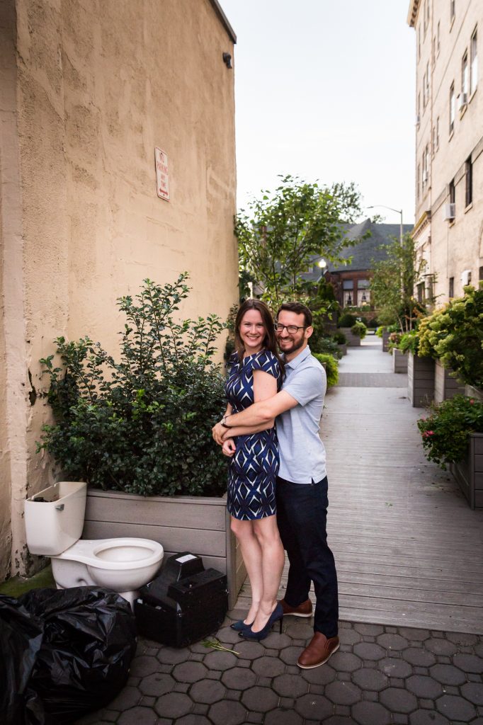 Couple posing in by toilet before their ketubah signing