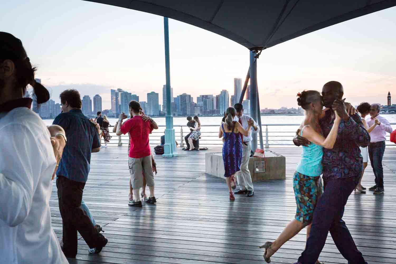 Couples dancing tango by the Hudson River for a Greenwich Village engagement portrait