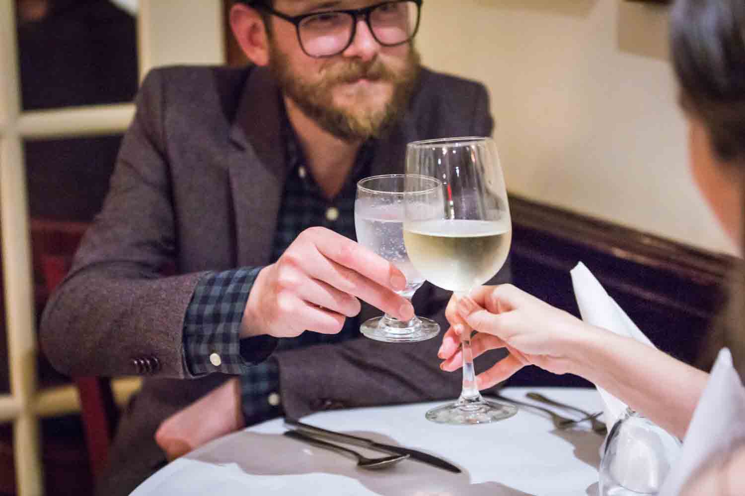 Couple toasting glasses in a restaurant