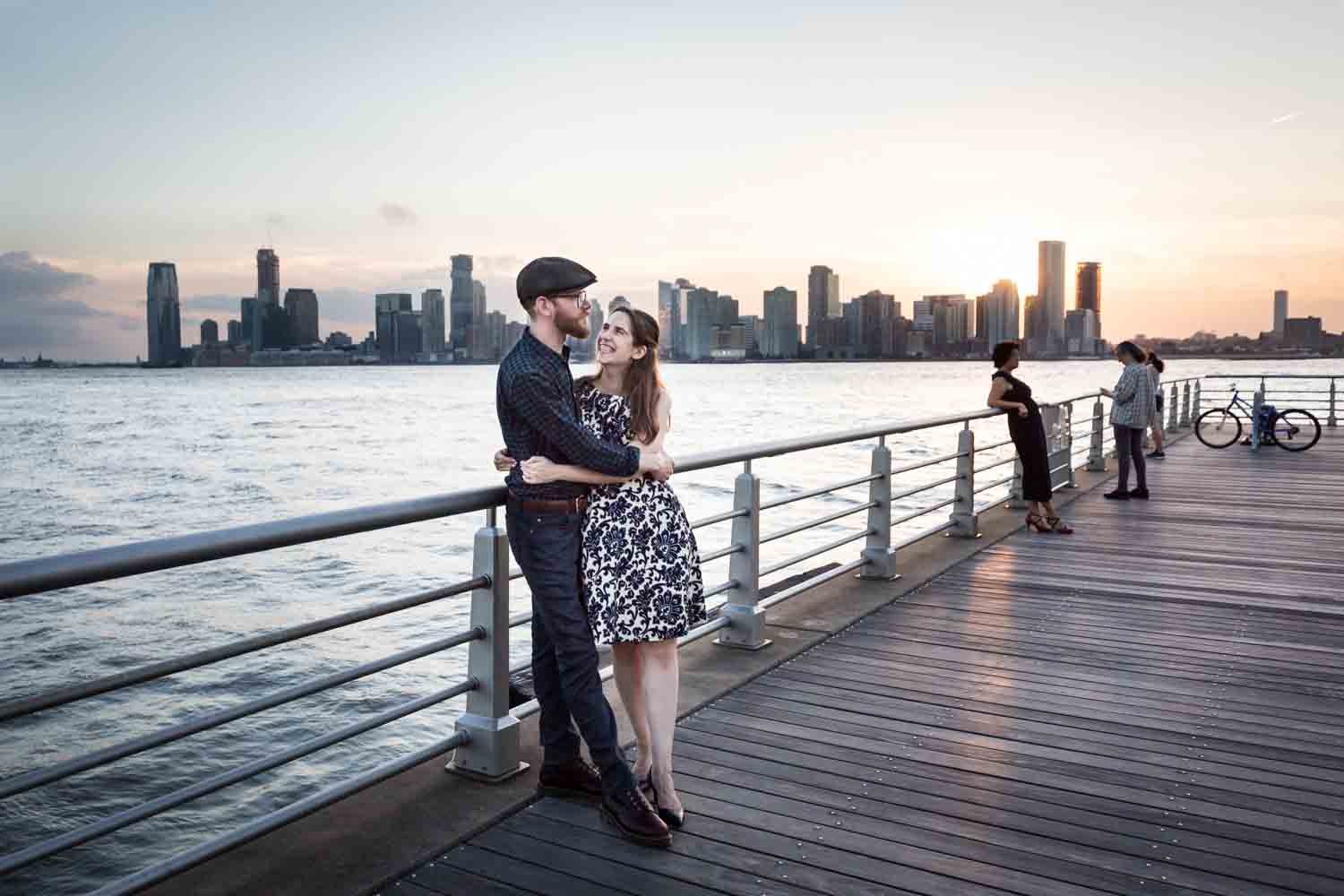 Couple leaning against railing in Hudson River waterfront park