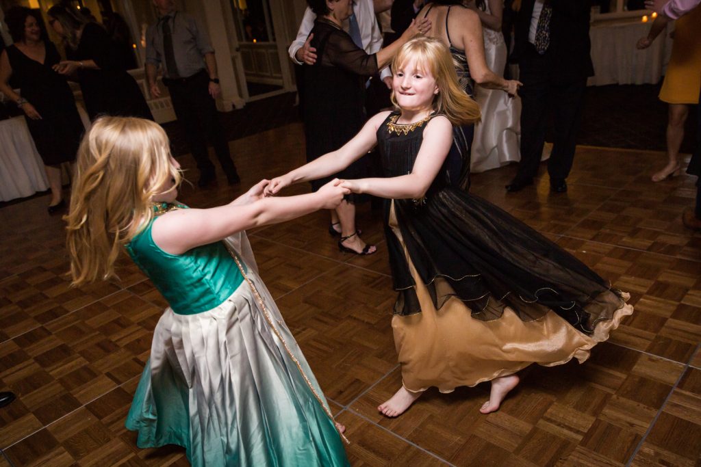 Two little girls dancing barefoot at Larchmont Shore Club wedding reception
