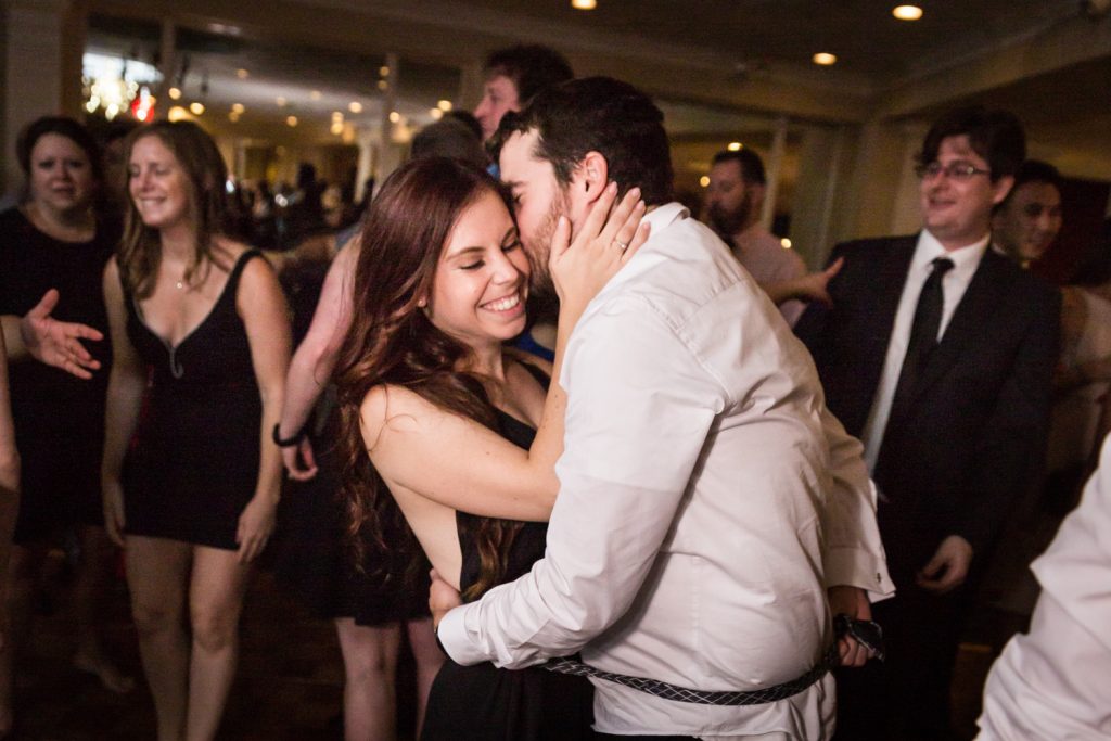 Couple dancing cheek-to-cheek at wedding reception