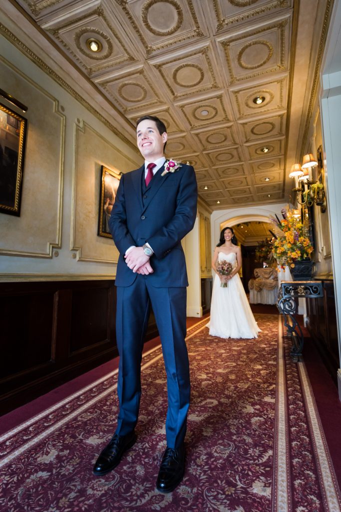 Bride behind groom before first look begins at a Westbury Manor wedding