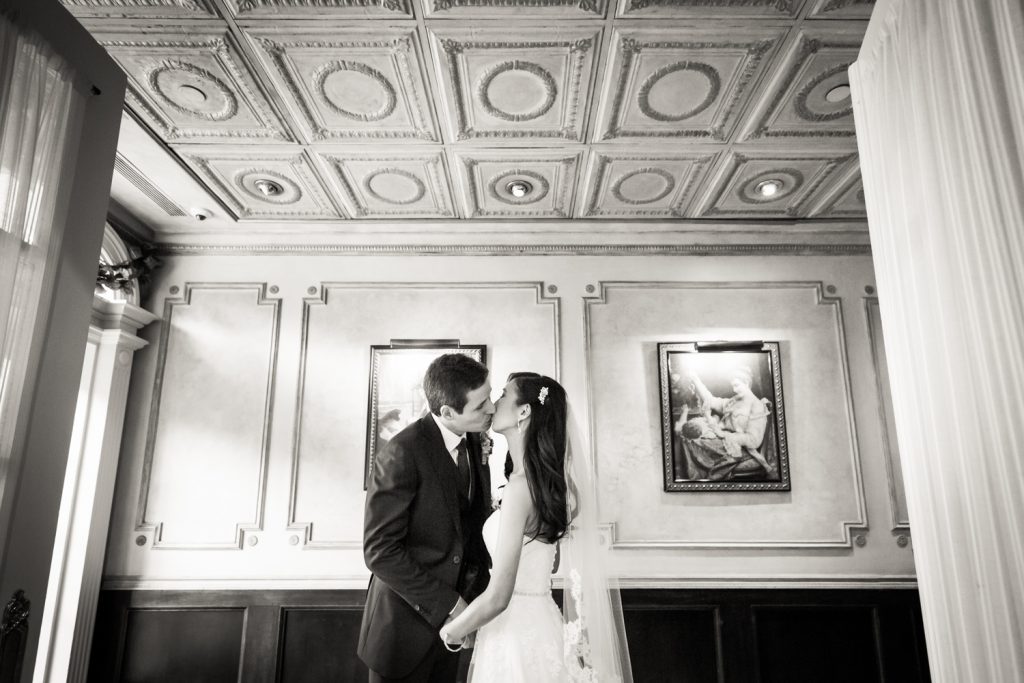 Black and white photo fo bride and groom kissing at a Westbury Manor wedding