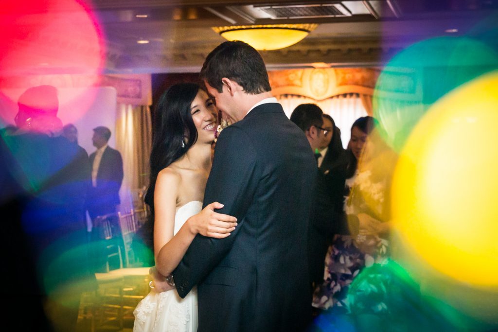 Bride and groom at first dance with multi colored lights