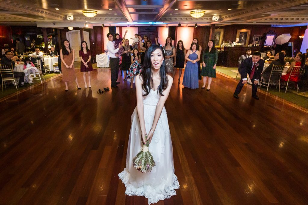 Bride about to throw bouquet at a Westbury Manor wedding