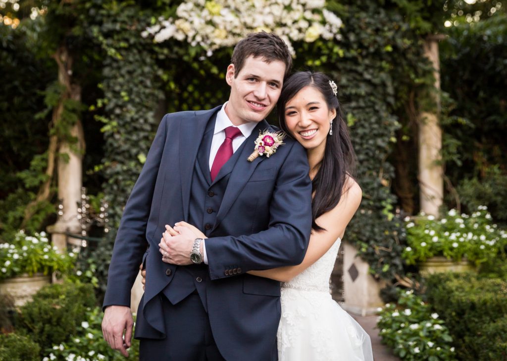 Portrait of bride and groom hugging in garden at a Westbury Manor wedding