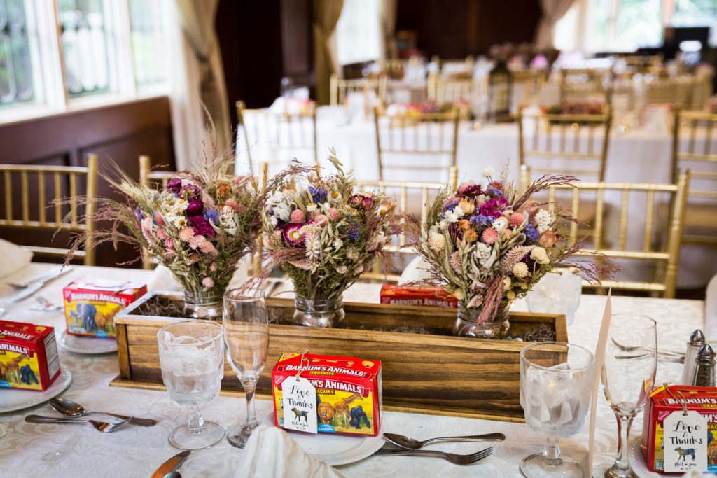 Table setting with dried flower bouquets in wooden trough at a Westbury Manor wedding