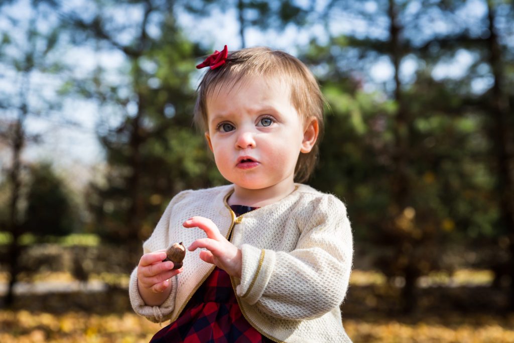 Child with acorn for article on how to get your kids to look into the camera