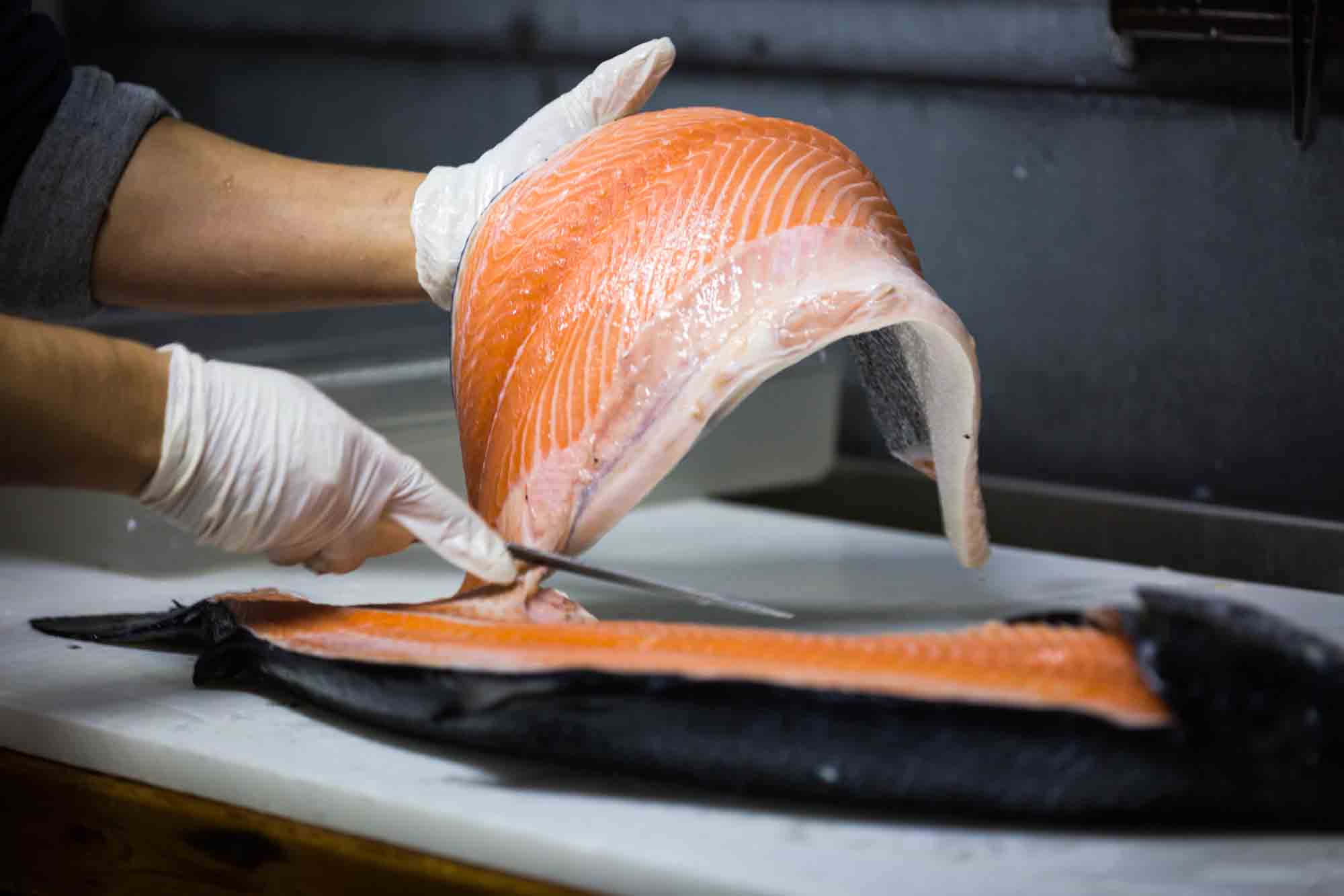 Hand holding salmon for an article on website photography tips