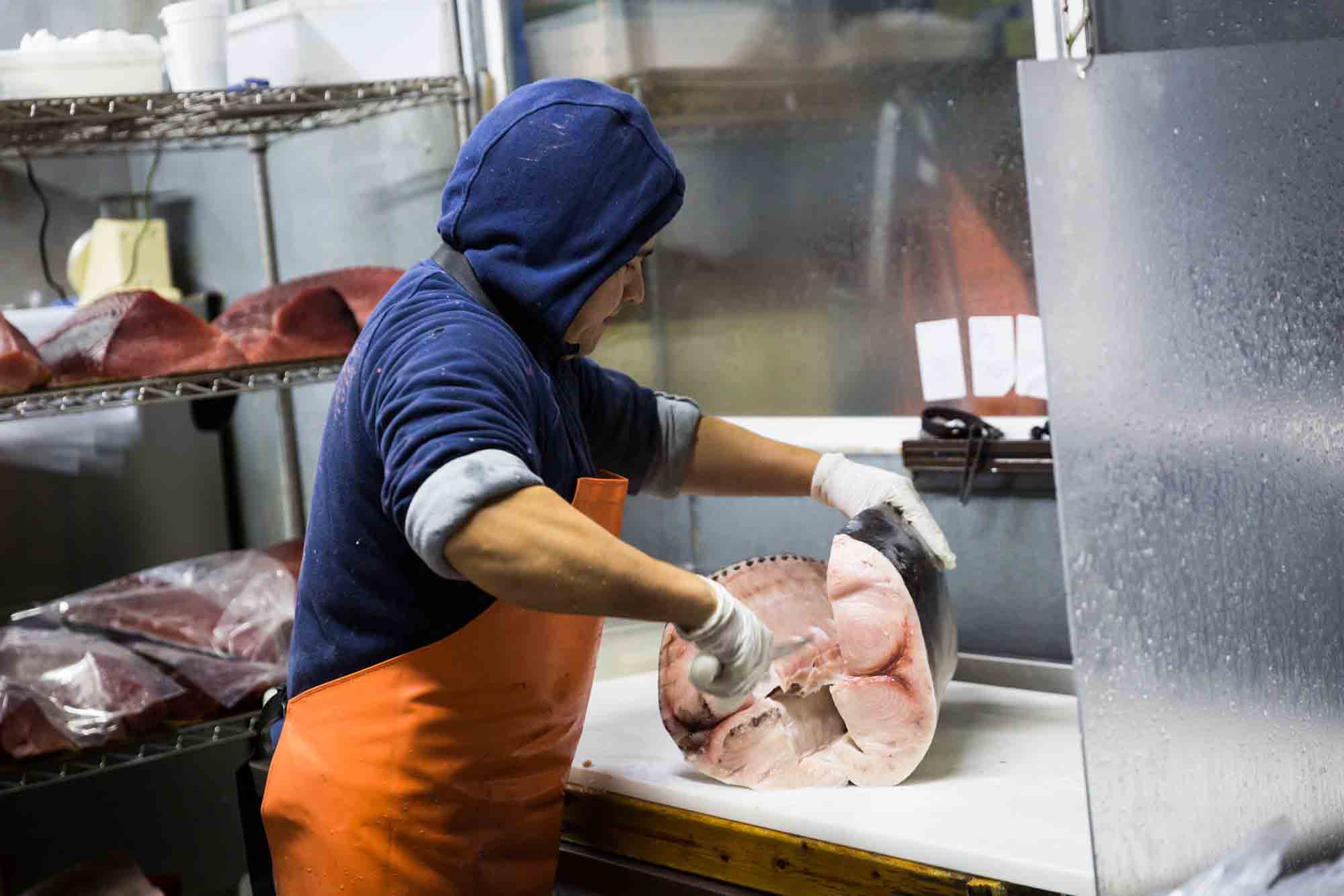 Man cutting fish for an article on website photography tips