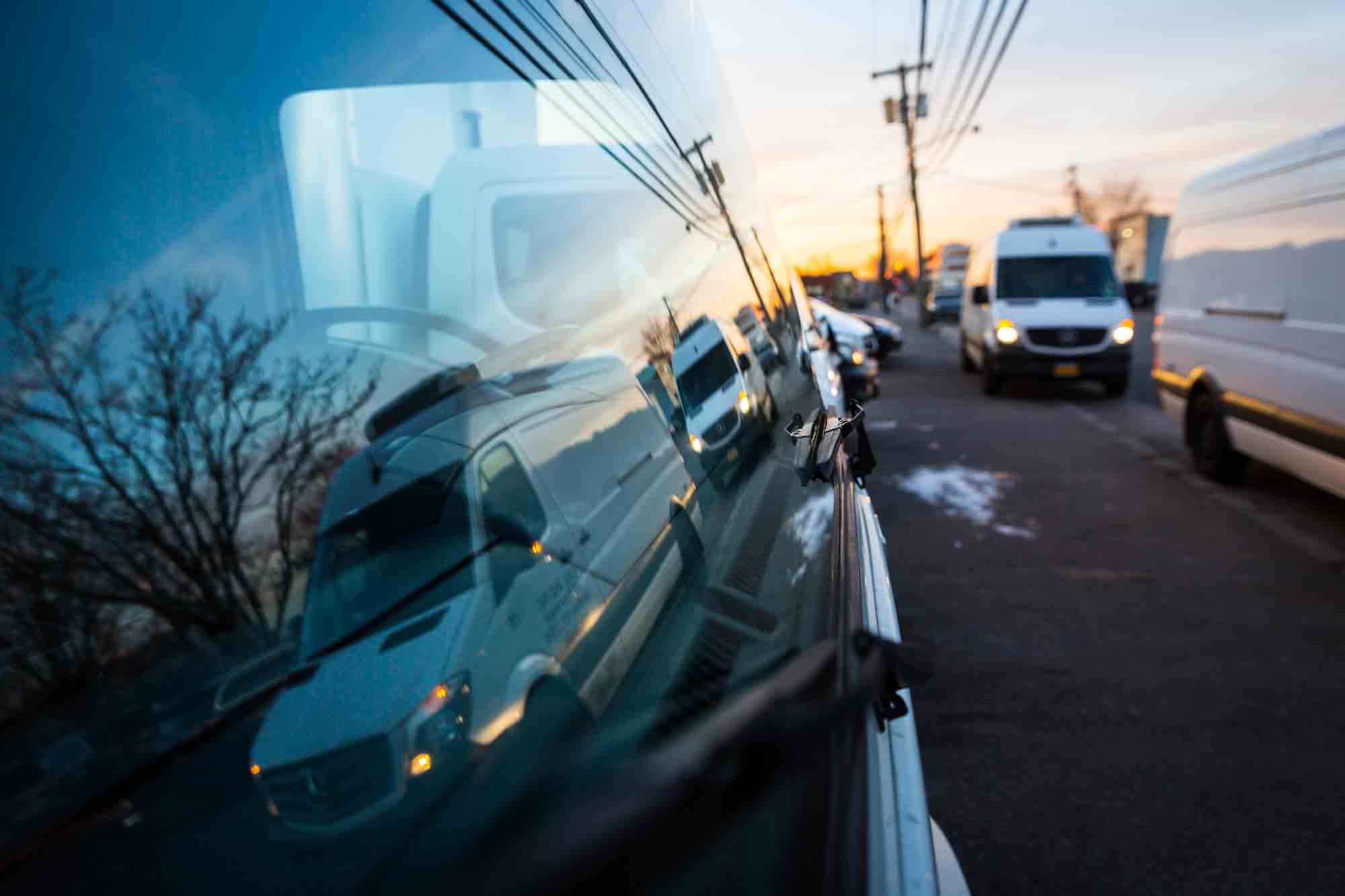 Trucks in a window reflection for an article on website photography tips