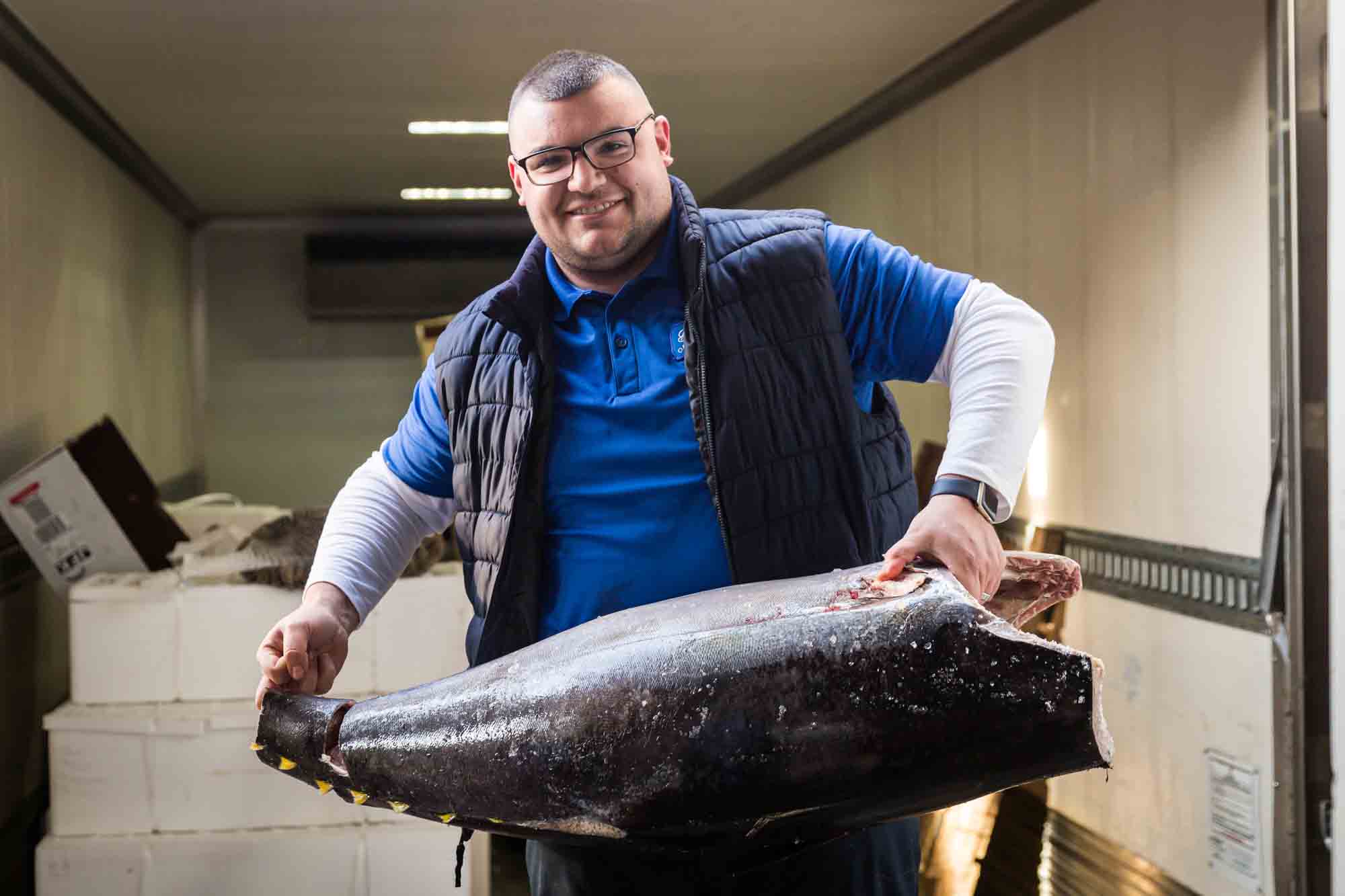 Man with large fish for an article on website photography tips