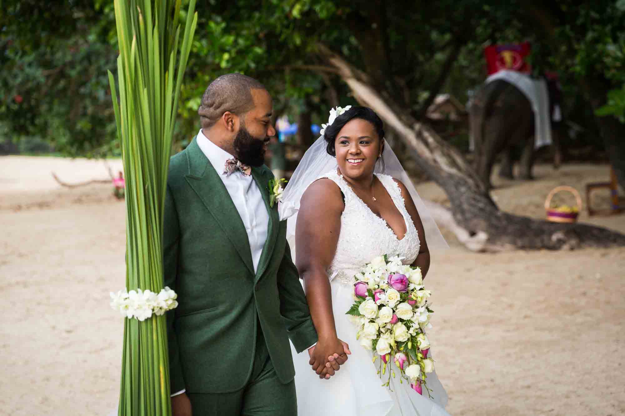 Bride and groom walking down aisle for an article on destination wedding photography tips