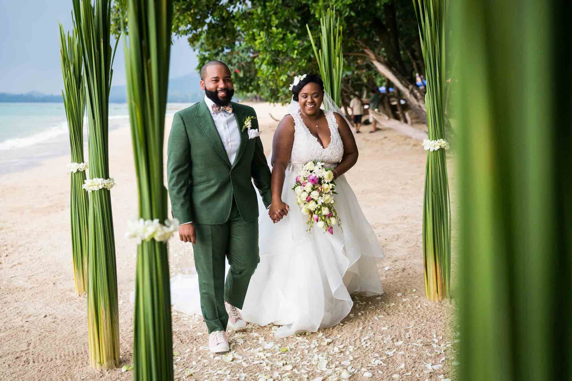 Bride and groom walking down aisle for an article on destination wedding photography tips