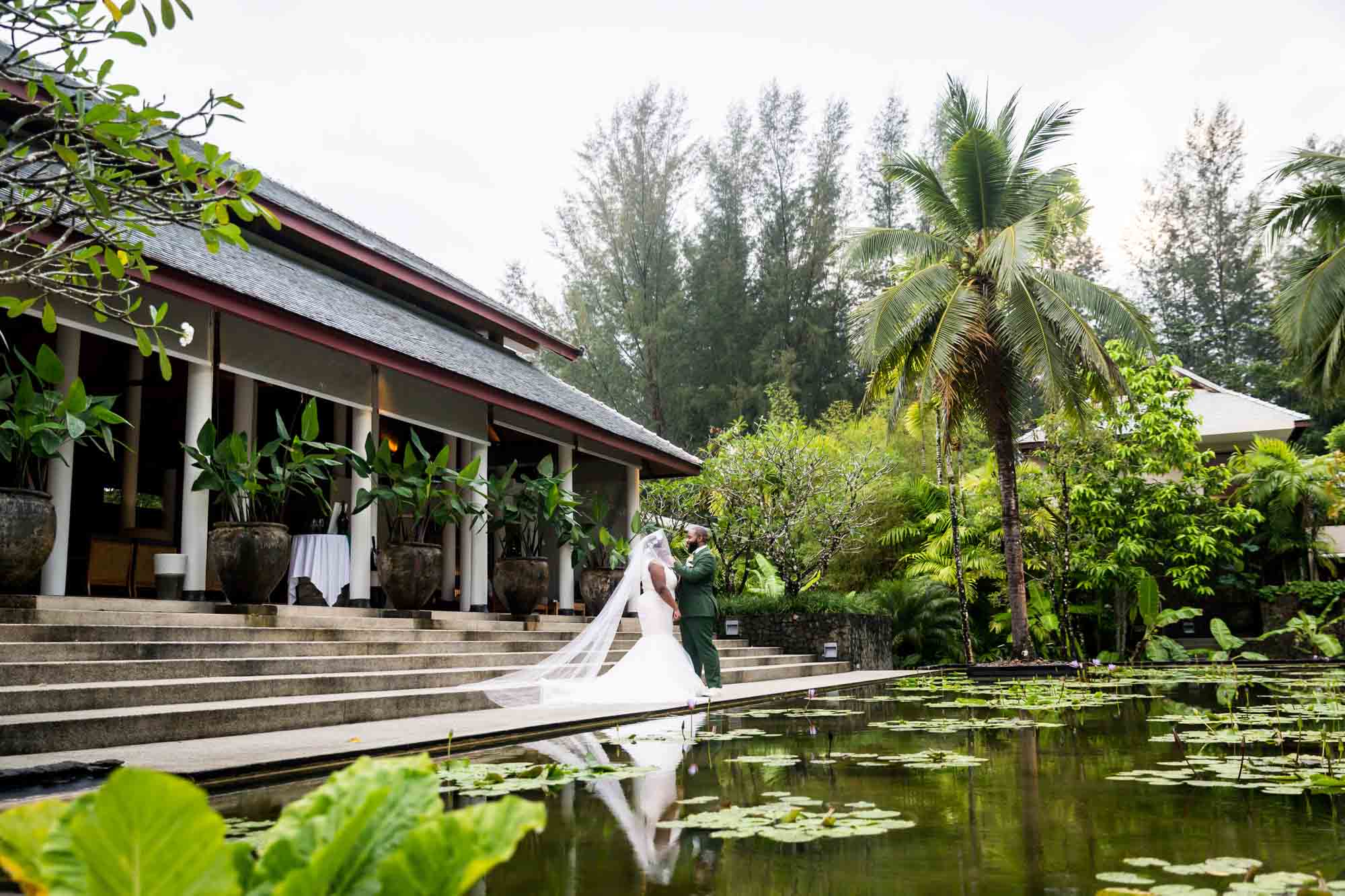 Bride and groom in front of pond for an article on destination wedding photography tips