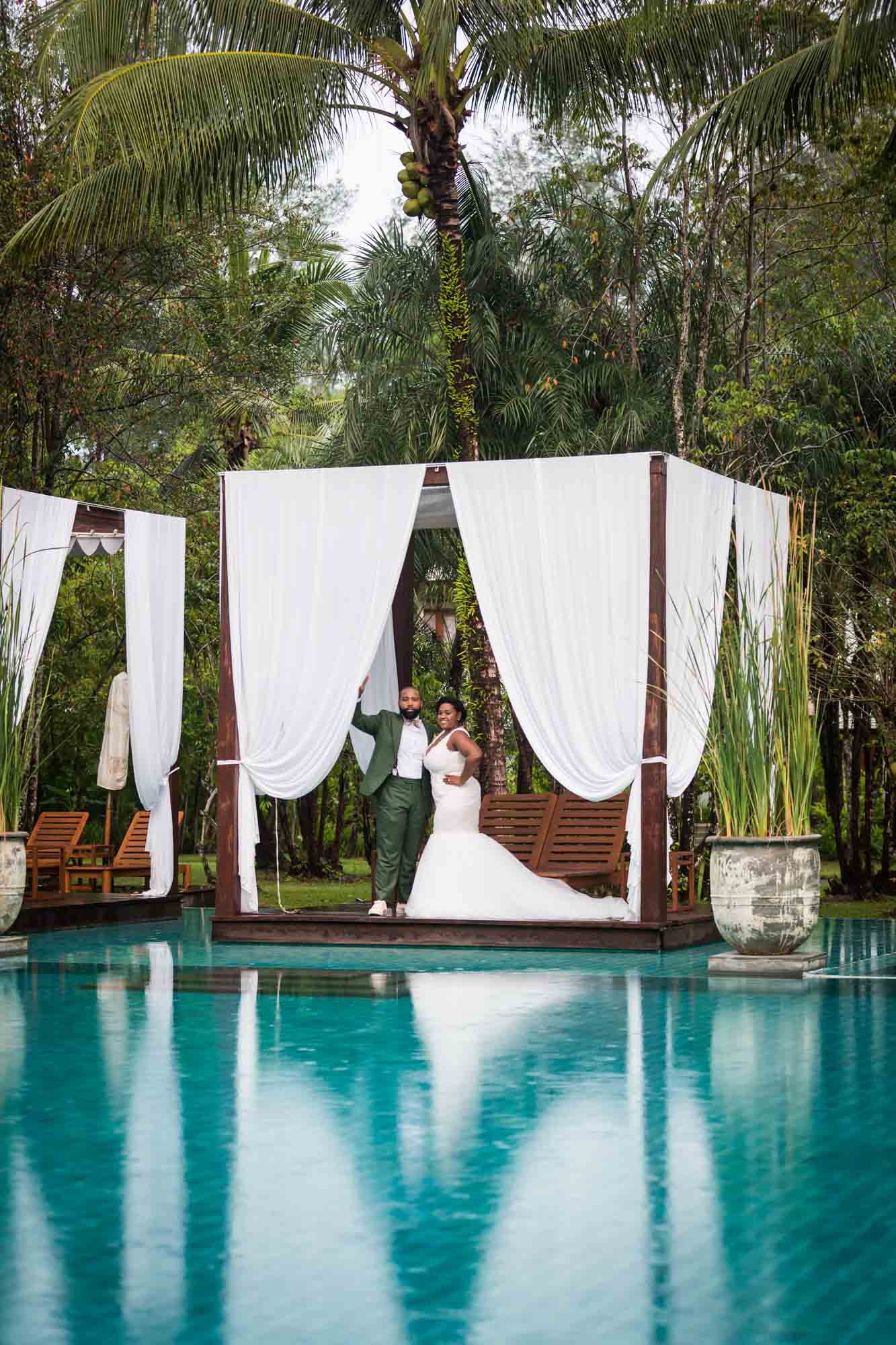 Bride and groom at a pool for an article on destination wedding photography tips