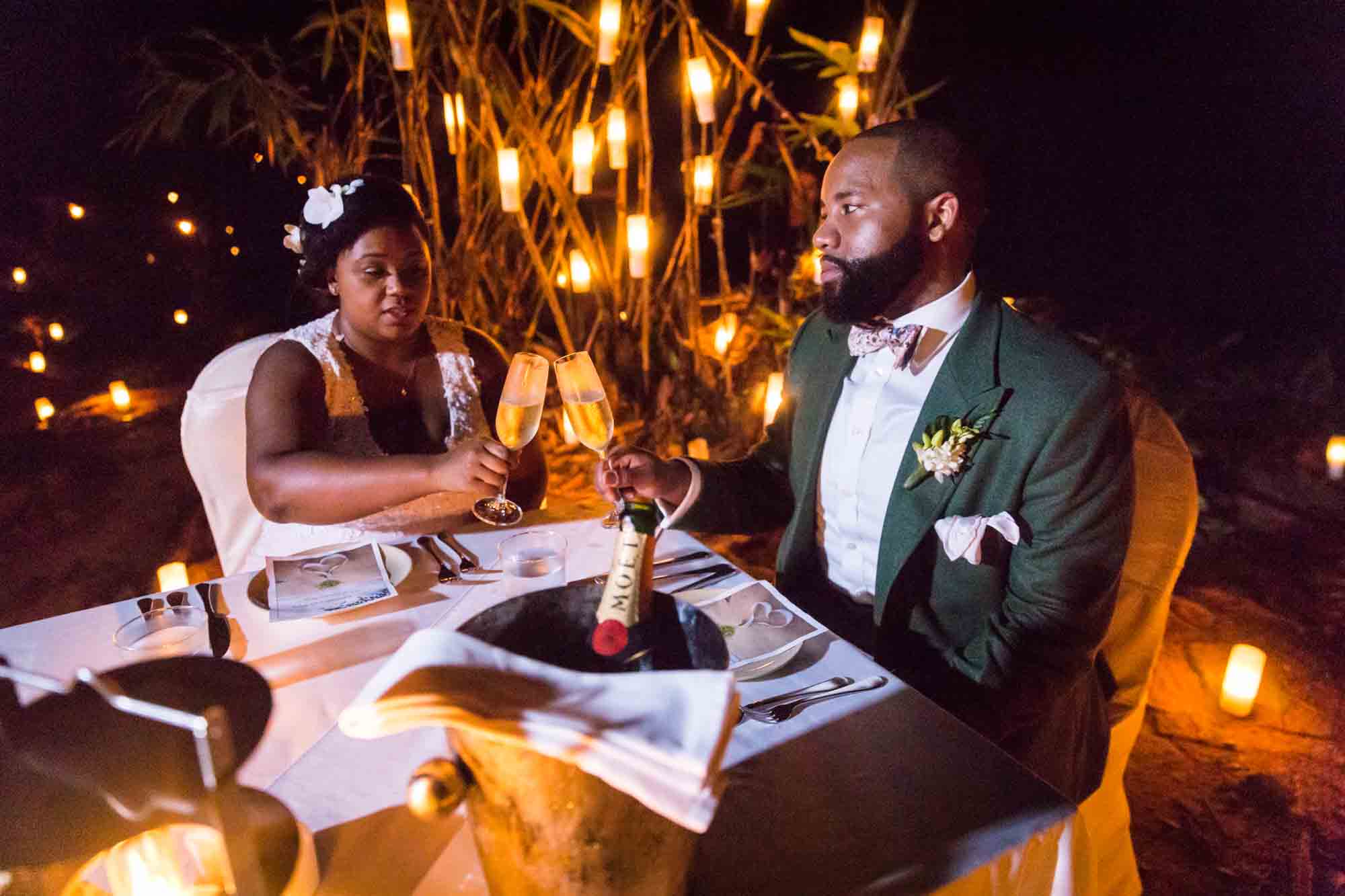 Bride and groom dining by candlelight for an article on destination wedding photography tips