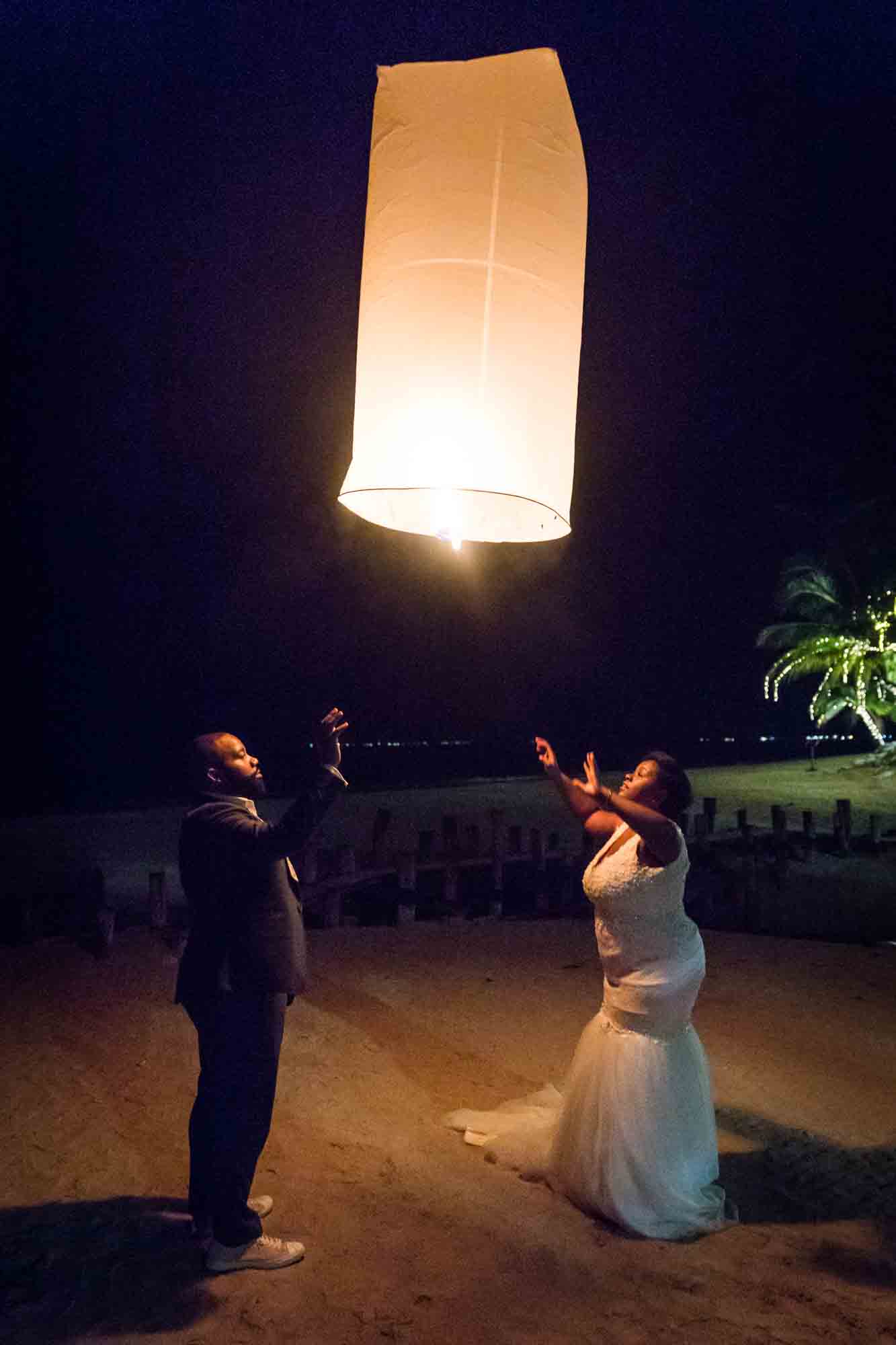 Bride and groom with lantern for an article on destination wedding photography tips