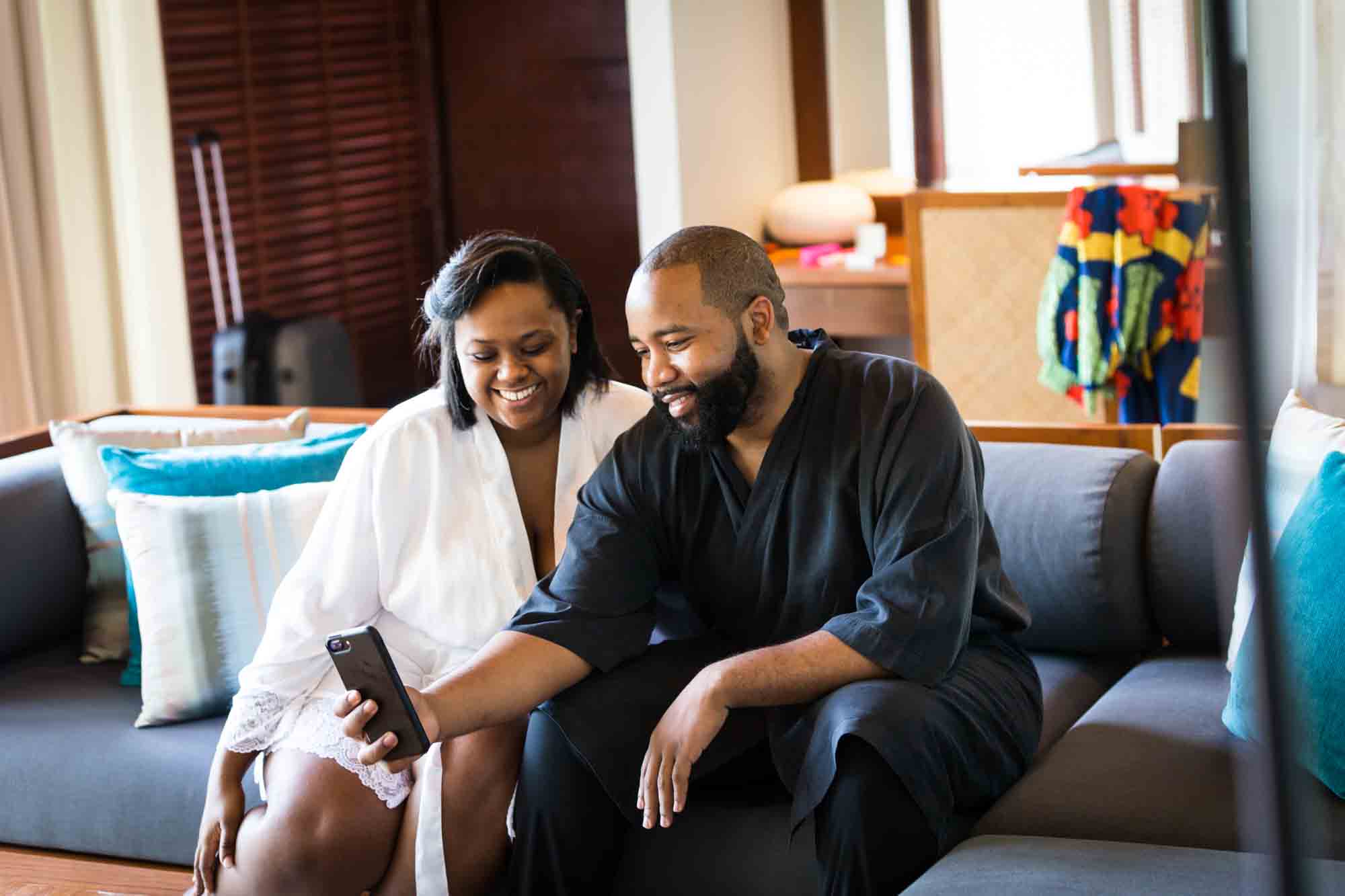 Couple speaking on cell phone for an article on destination wedding planning tips