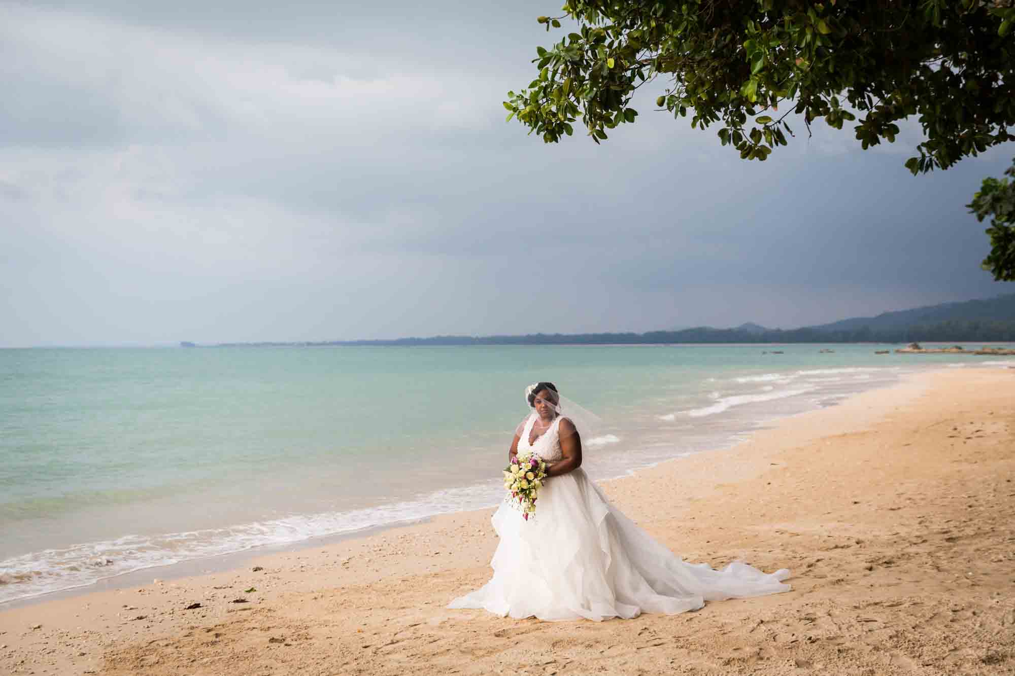 Bride on beach for an article on destination wedding planning tips
