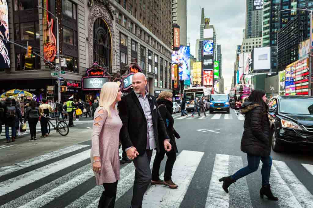 Couple walking in crosswalk through Times Square