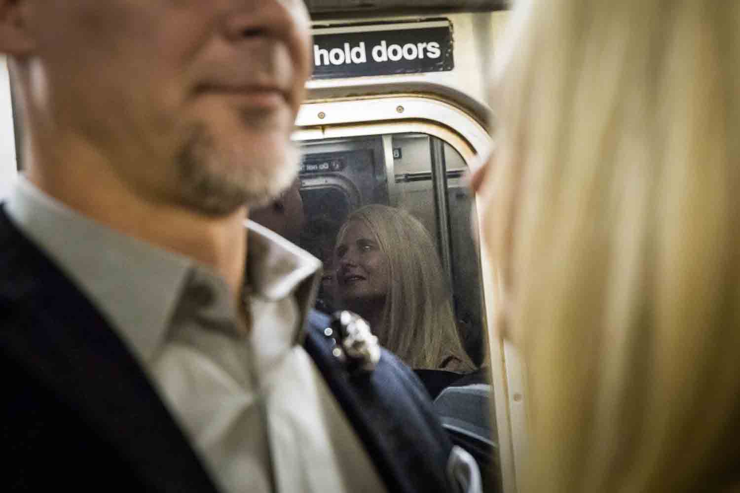 Reflection of woman in window of subway car