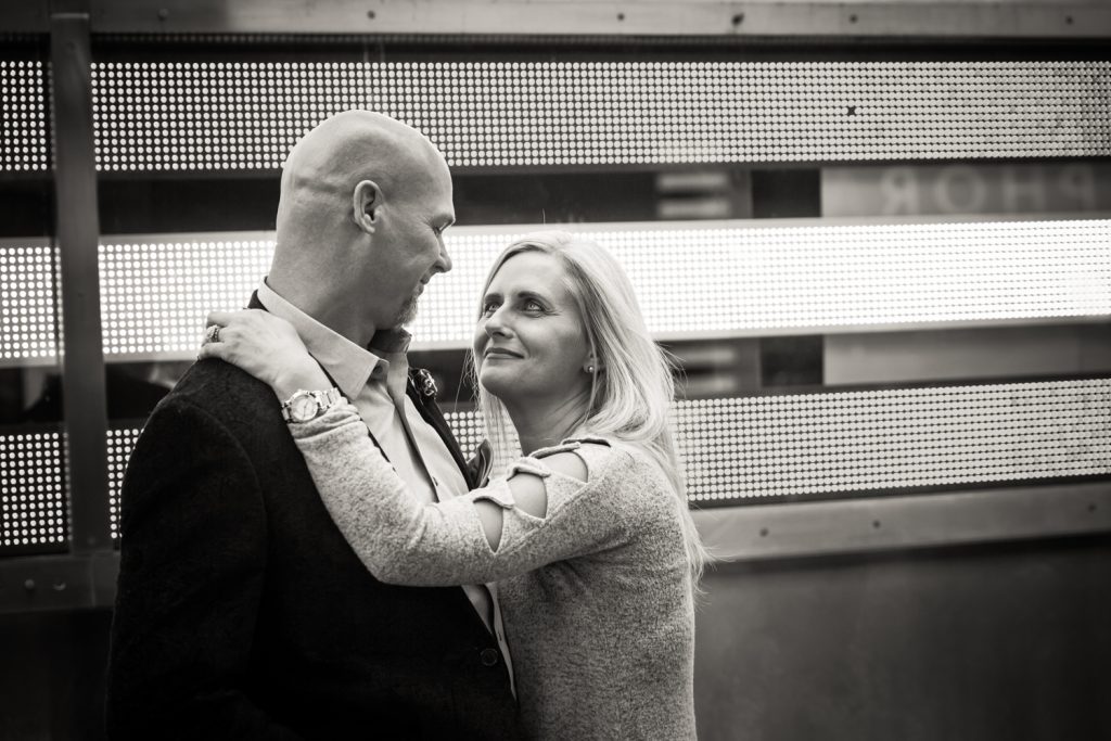Black and white photo of couple hugging in Times Square
