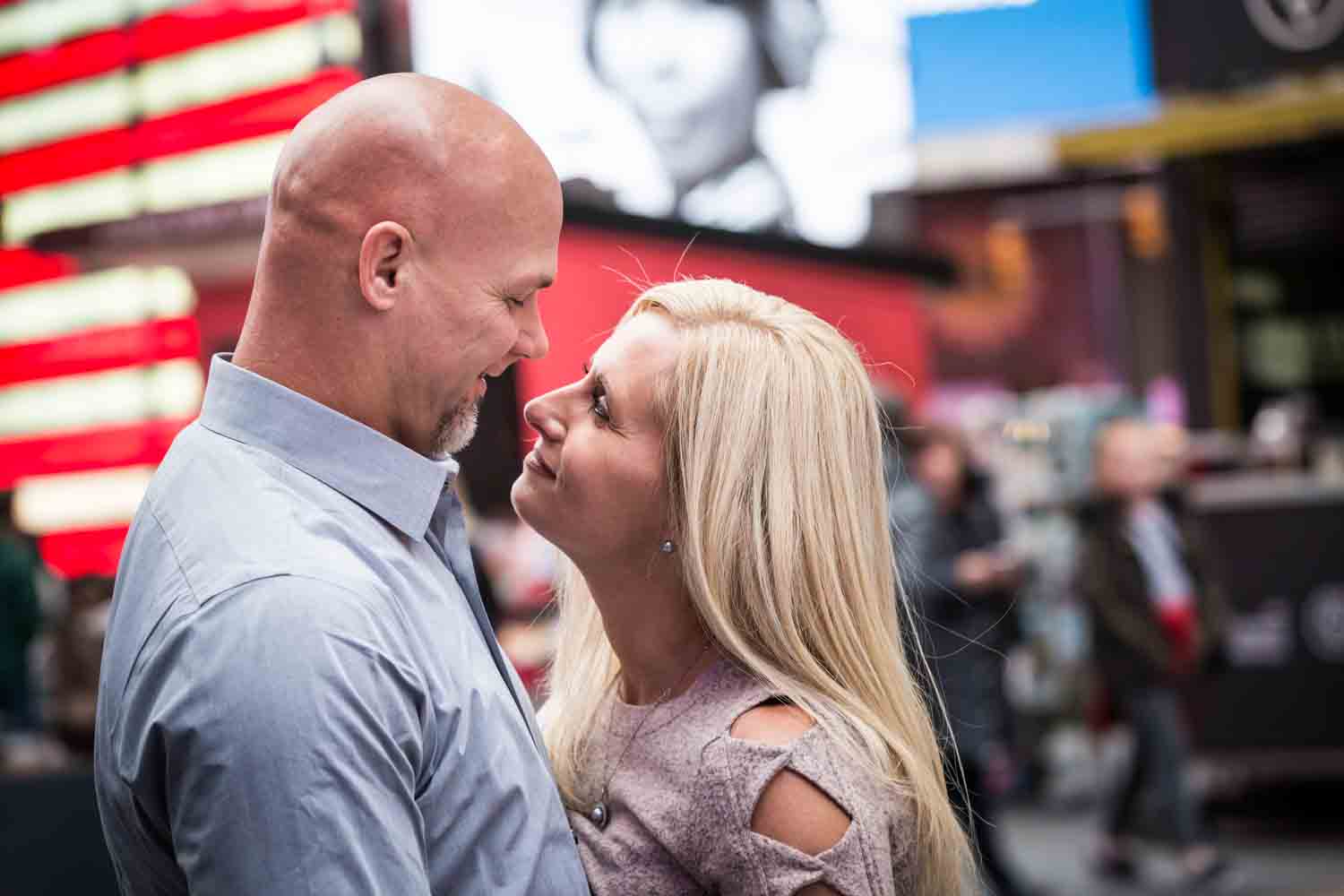 Couple hugging in Times Square for an article on how to propose on top of the Empire State Building