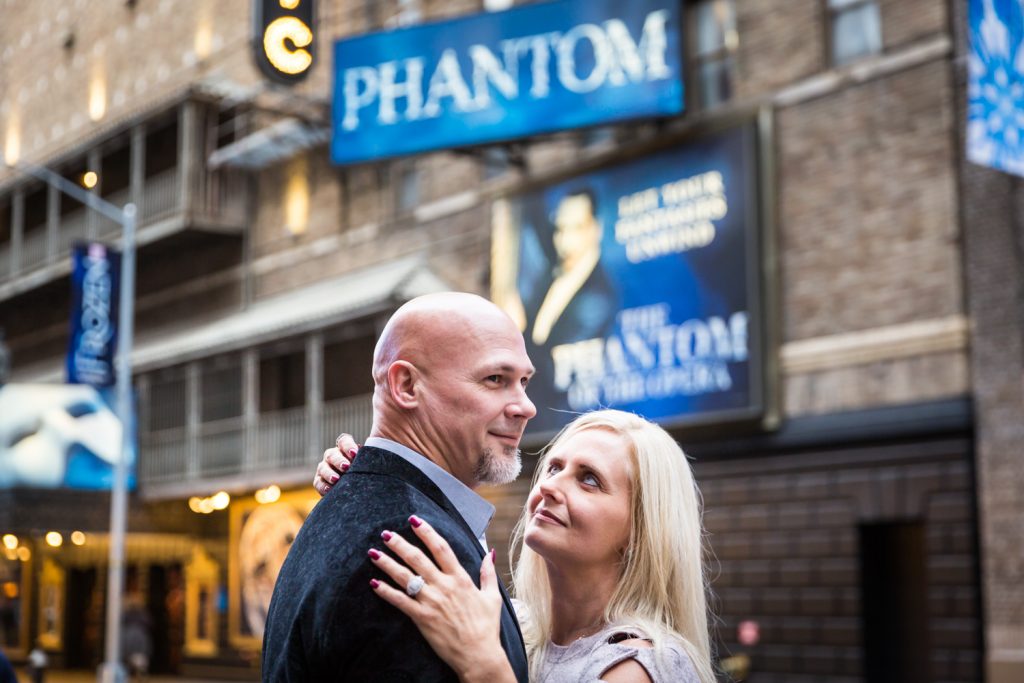 Couple in front of Phantom theater in Times Square