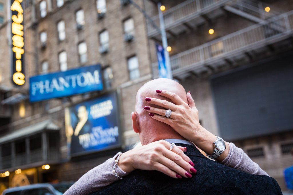 Close up on woman embracing bald man with hand on his head