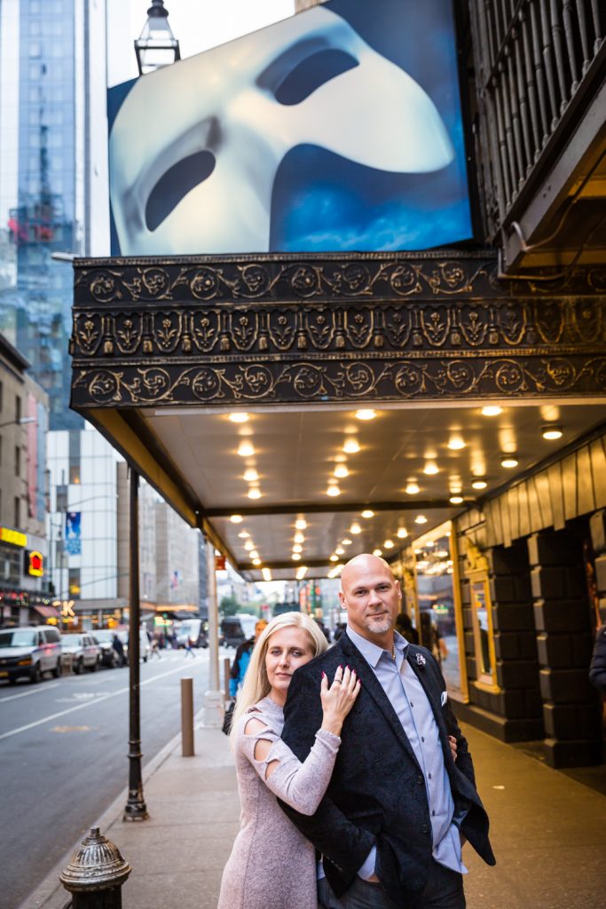 Couple in front of Broadway theater for an article on how to propose on top of the Empire State Building