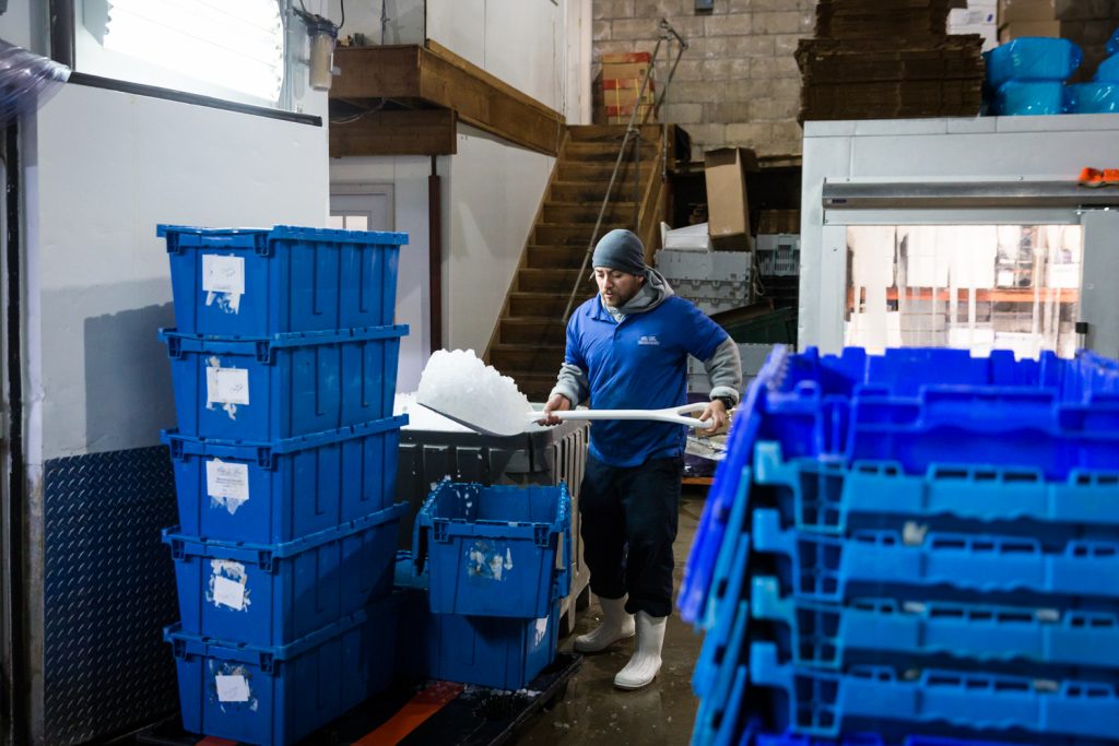 Worker shoveling ice for an article on website photography tips